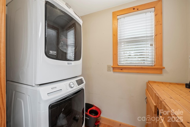 clothes washing area with stacked washer / drying machine