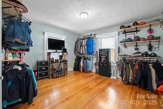 walk in closet with wood-type flooring