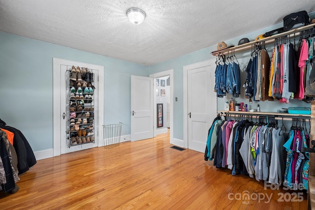 spacious closet with hardwood / wood-style floors