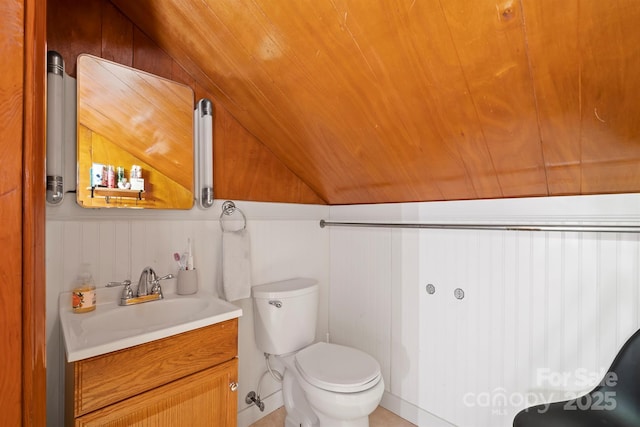 bathroom featuring vanity, vaulted ceiling, and toilet