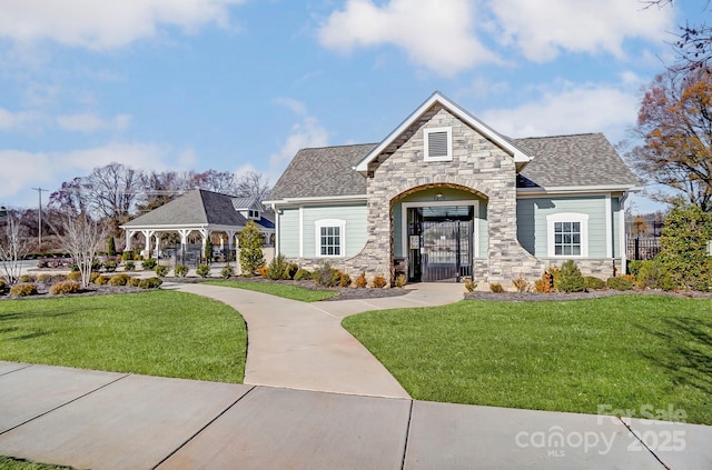 view of front of property featuring a gazebo and a front lawn