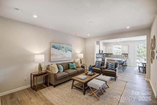 living room with sink and light hardwood / wood-style flooring