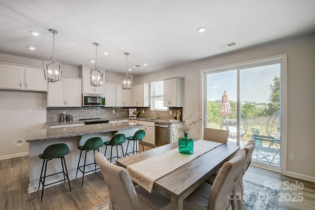 dining room with dark hardwood / wood-style flooring and sink