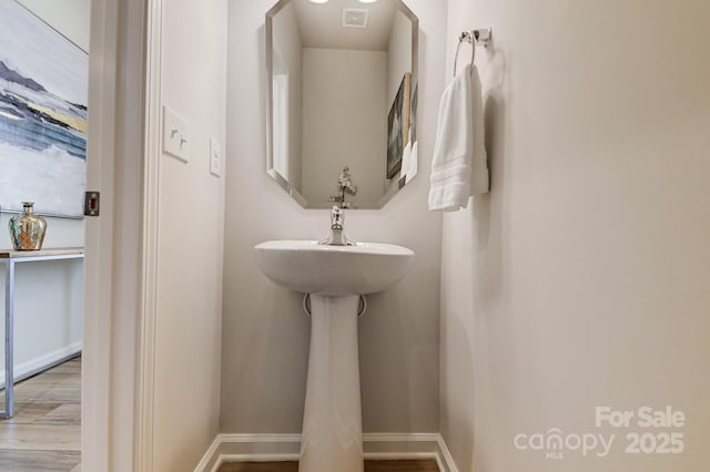 bathroom with hardwood / wood-style flooring