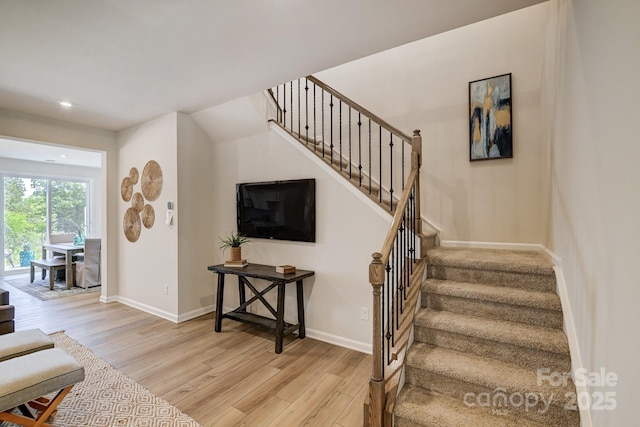 staircase featuring hardwood / wood-style floors