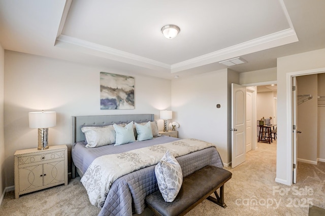 carpeted bedroom with crown molding and a raised ceiling