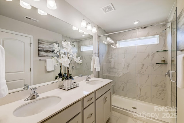 bathroom featuring vanity, an enclosed shower, and a wealth of natural light