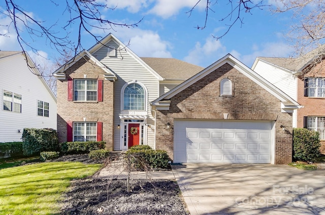 traditional-style home with a front yard, brick siding, driveway, and an attached garage