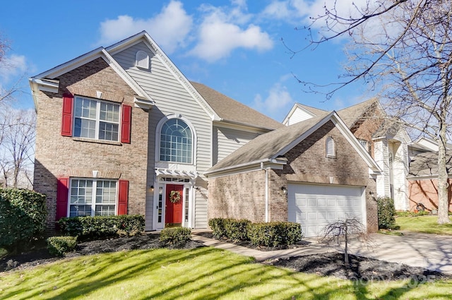 traditional-style house with a garage, a front lawn, concrete driveway, and brick siding