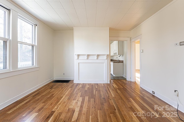 unfurnished living room with dark wood-type flooring