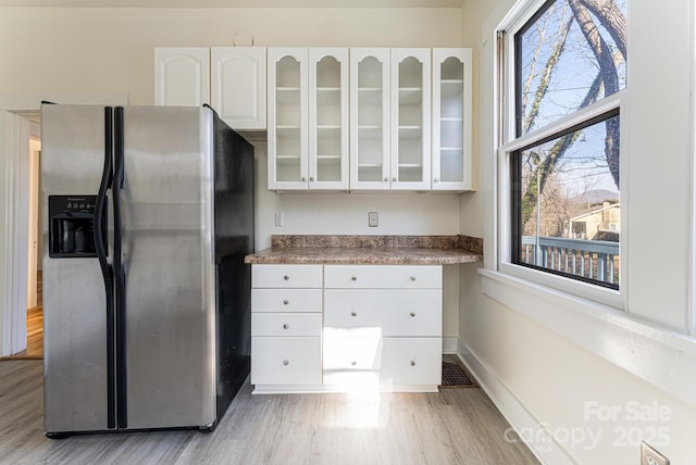 kitchen featuring white cabinetry, stainless steel fridge, and light hardwood / wood-style flooring