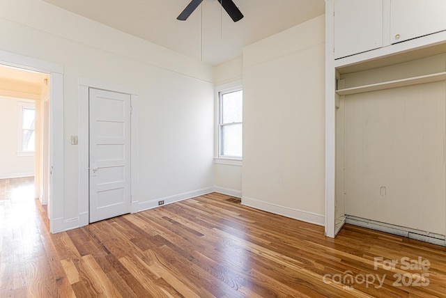 unfurnished bedroom featuring hardwood / wood-style flooring and ceiling fan