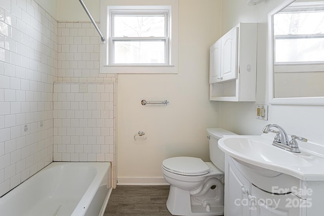 full bathroom featuring vanity, hardwood / wood-style flooring, a wealth of natural light, and toilet