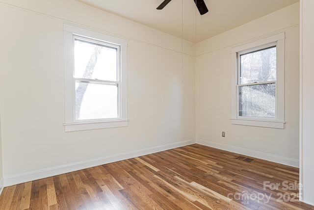 spare room featuring hardwood / wood-style floors and ceiling fan