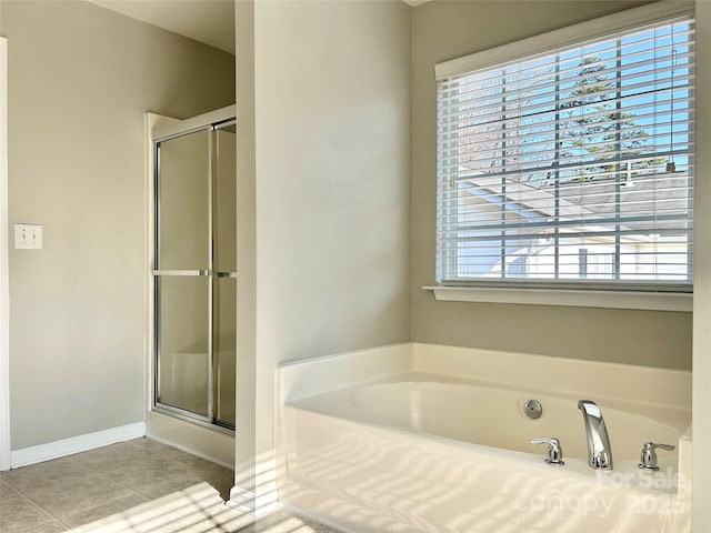 full bath with tile patterned flooring, a garden tub, an enclosed shower, and baseboards