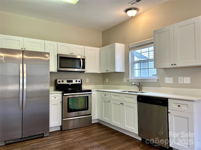 kitchen with a sink, white cabinetry, and stainless steel appliances