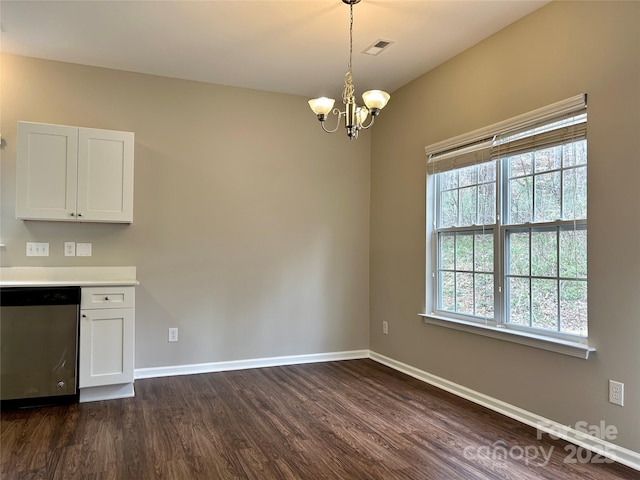 unfurnished dining area featuring a notable chandelier, visible vents, baseboards, and dark wood-style floors