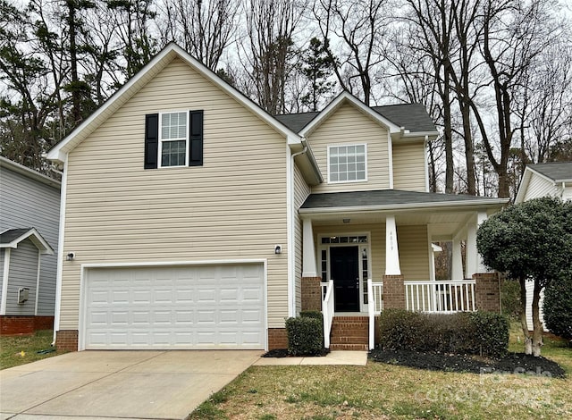 view of front facade featuring concrete driveway, a garage, and covered porch