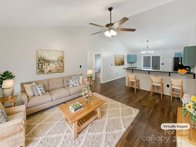 living room featuring high vaulted ceiling, dark hardwood / wood-style floors, and ceiling fan with notable chandelier