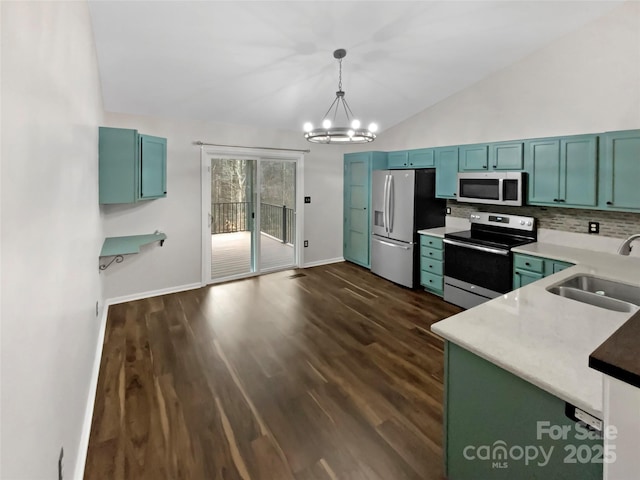 kitchen with lofted ceiling, sink, decorative light fixtures, a notable chandelier, and stainless steel appliances