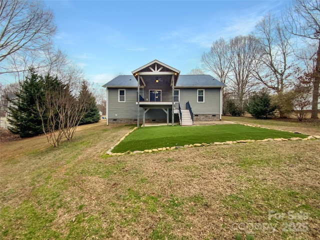 rear view of house featuring a lawn