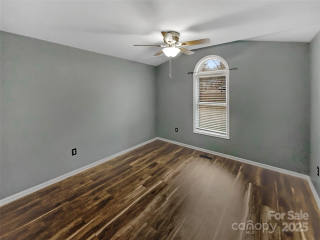 unfurnished room with dark hardwood / wood-style floors and ceiling fan