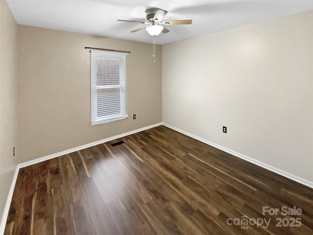 unfurnished room with dark wood-type flooring and ceiling fan