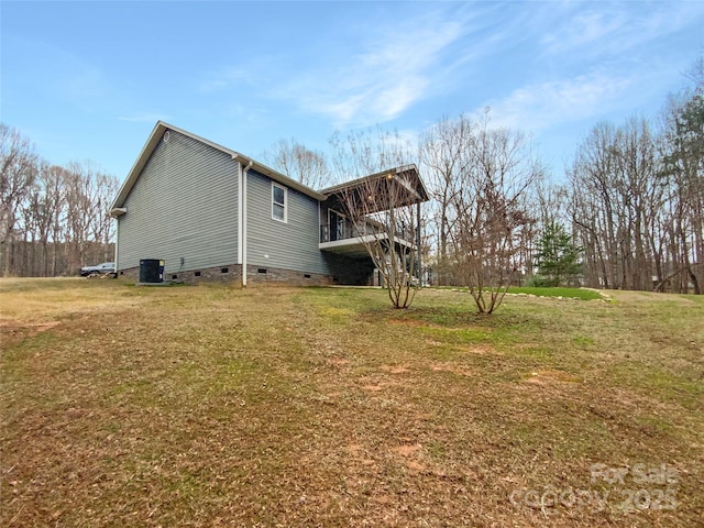 view of side of home featuring central AC unit and a lawn