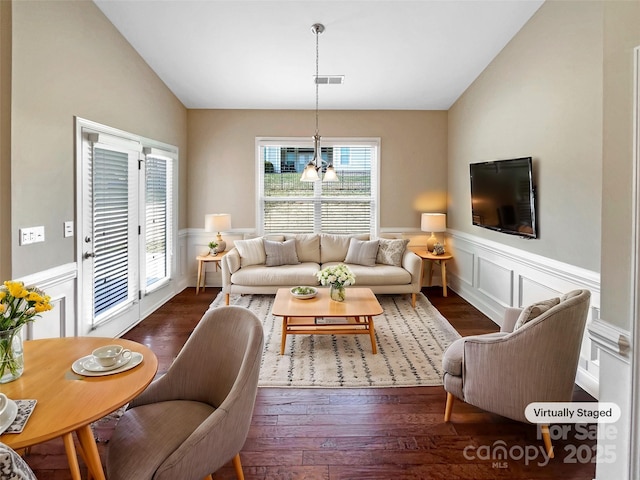 living room featuring dark hardwood / wood-style floors and vaulted ceiling