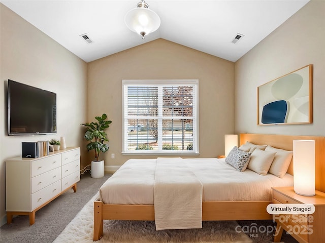 carpeted bedroom with vaulted ceiling