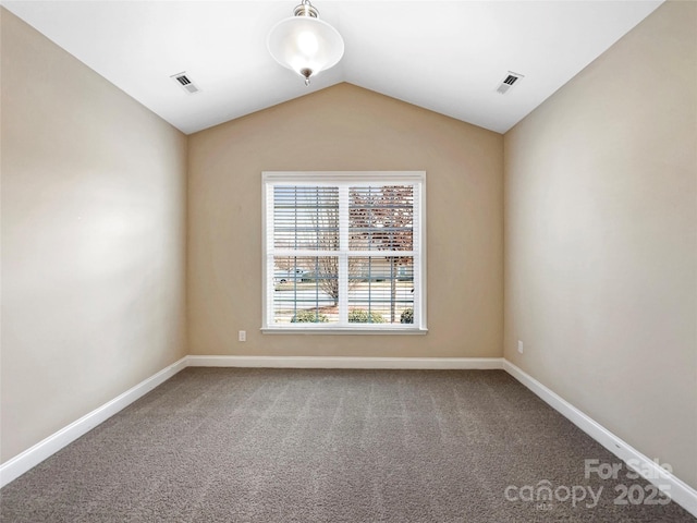 empty room with vaulted ceiling and carpet