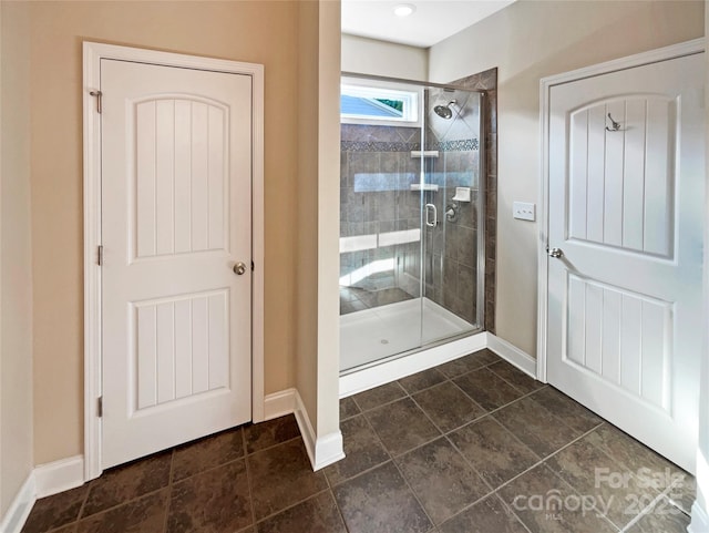 bathroom with a shower with shower door