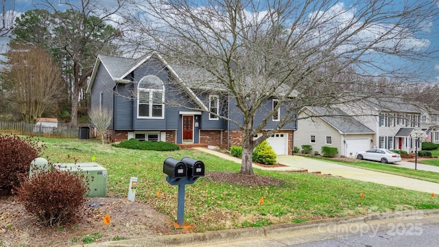 bi-level home featuring a garage and a front lawn