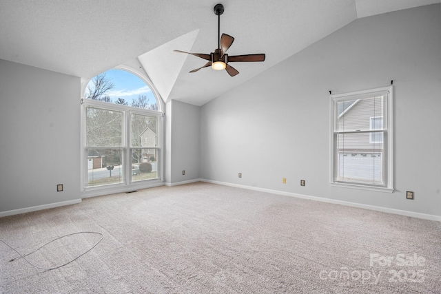 unfurnished living room with ceiling fan, light colored carpet, lofted ceiling, and a textured ceiling