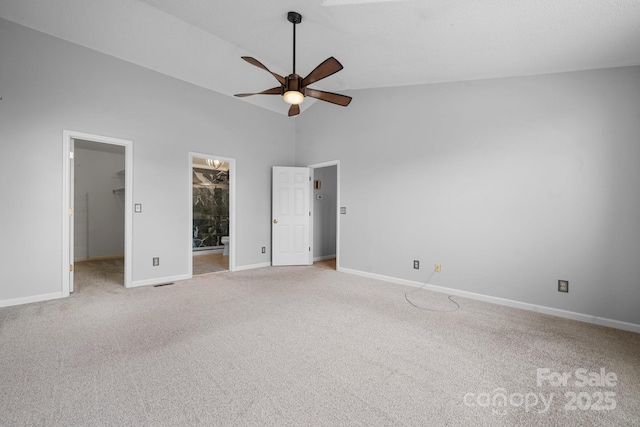 unfurnished bedroom with connected bathroom, high vaulted ceiling, carpet flooring, a spacious closet, and ceiling fan