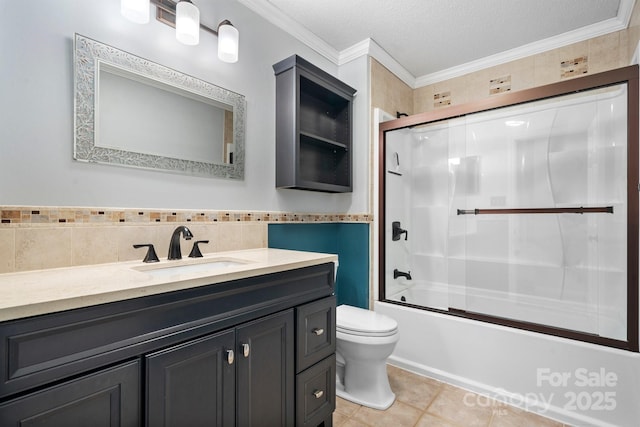 full bathroom featuring tile patterned floors, bath / shower combo with glass door, ornamental molding, and toilet