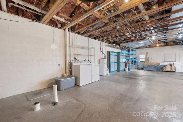 basement featuring washing machine and dryer and water heater