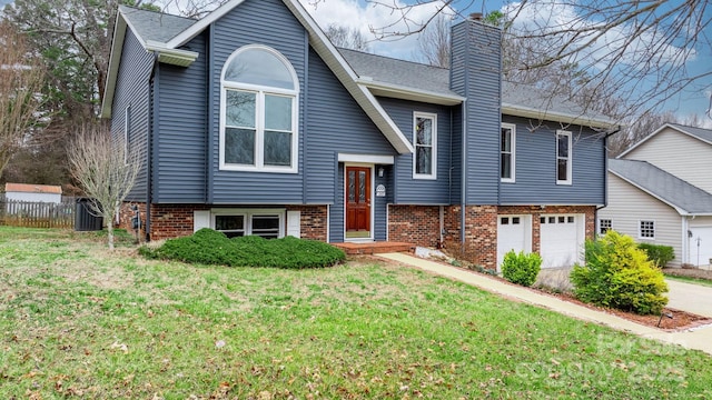 split foyer home with a garage, central AC, and a front yard