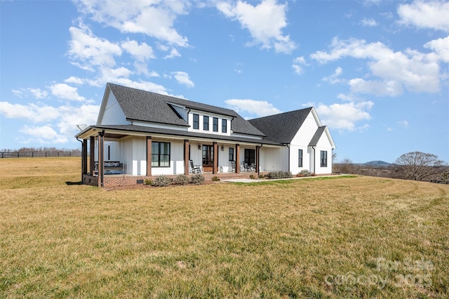 view of front of property with covered porch and a front lawn