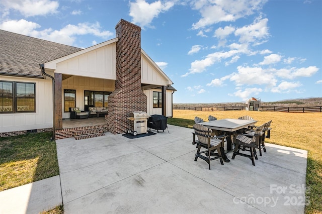 view of patio / terrace with outdoor lounge area, a grill, and a rural view