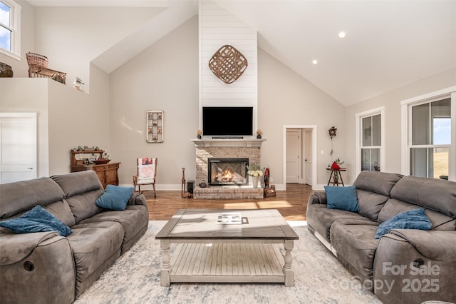 living room with high vaulted ceiling and hardwood / wood-style floors