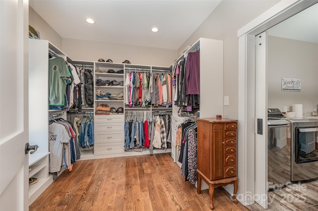 walk in closet featuring washing machine and clothes dryer and wood-type flooring