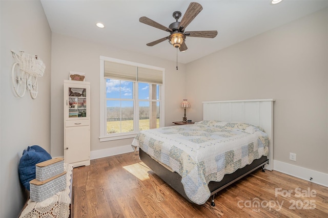 bedroom featuring hardwood / wood-style flooring and ceiling fan