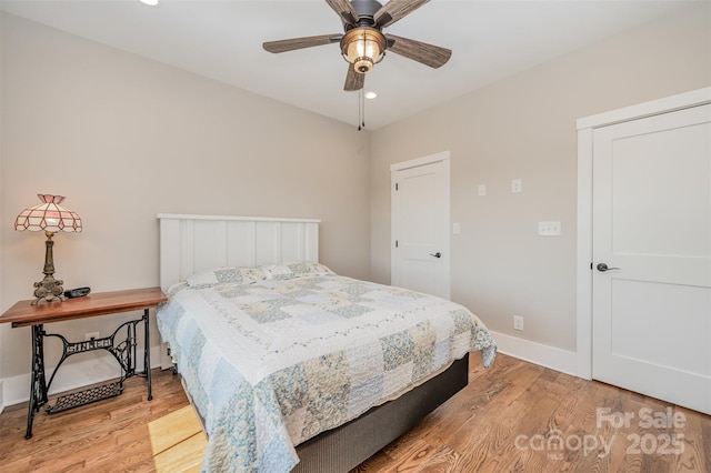 bedroom with ceiling fan and light hardwood / wood-style flooring