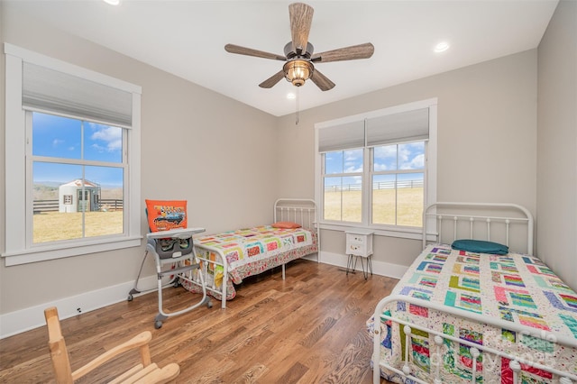 bedroom featuring hardwood / wood-style floors and ceiling fan