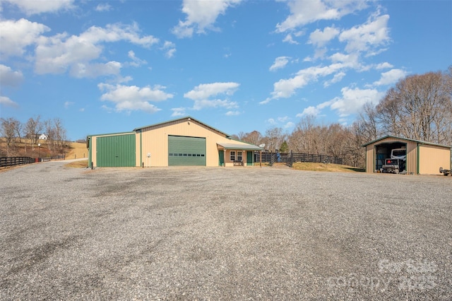 exterior space featuring an outbuilding, a garage, and a carport