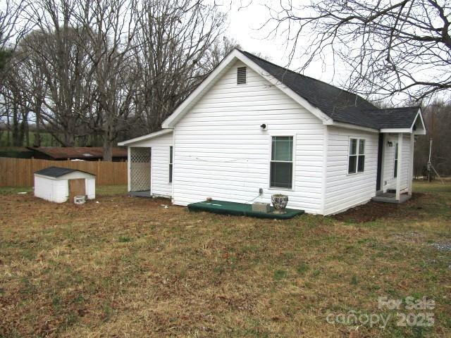 view of side of home featuring a yard