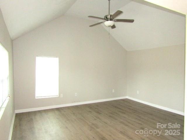 spare room featuring vaulted ceiling, ceiling fan, and dark hardwood / wood-style flooring