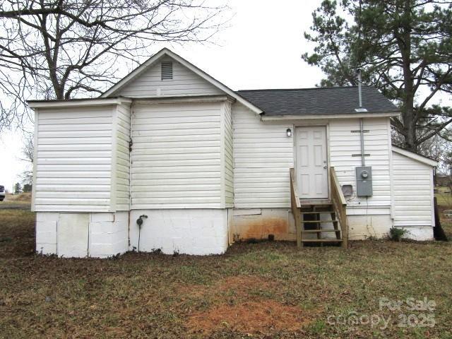 back of property featuring a lawn