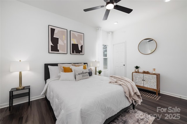 bedroom with dark hardwood / wood-style floors and ceiling fan